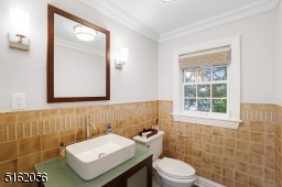 Powder Room with modern vanity, tile floor and two sconces