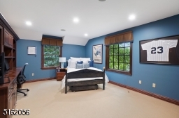 Bedroom 2 is en-suite with wall-to-wall carpeting, windows at two exposures, recessed lights, vaulted ceiling, built-in desk with shelves and cabinetry and a double fitted closet
