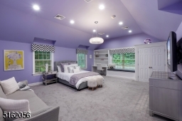Bedroom 3 with wall-to-wall carpeting,  a vaulted ceiling, windows at two exposures (including a double window and a built-in window seat) modern light fixture and recessed lighting, two double fitted closets and a sitting area