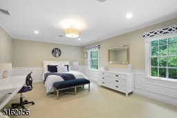 Bedroom 4 with wall-to-wall carpeting, double window, deep moldings, recessed lights, two double French door closets with built-ins, flushmount light and built-in speakers