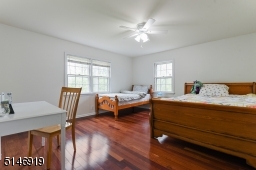 spacious bedroom with closet, wood floor