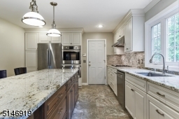 you will love to cook in this upscaled designer kitchen with wood cabinets, center island, granite counter top, Bosch SS appliances. The door to the garage offers ez access into the kitchen