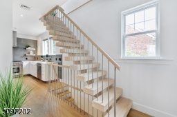 The focal point of the first floor is the open riser staircase with 4 inch thick oak treads. Stairs and metal railings were custom designed by renowned local stair craftsman.