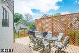 The outdoor deck steps down to a private grassy backyard perfect for a game of volleyball or tag football.