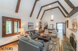 Wow wow wow! A lifetime of memories await in this impressive (awe inspiring) living room adorned with a gorgeous exposed beamed cathedral ceiling, stone fireplace, milky white walls and fabulous oversized windows.