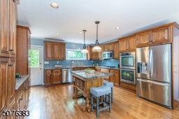 Fit for a chef or the everyday foodie, this epicurean kitchen is outfitted with custom cabinetry, sweeping granite countertops, professional grade stainless steel appliances and a custom center island with seating for four.