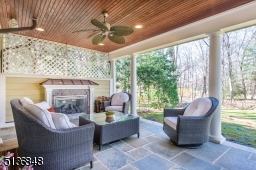The covered outdoor living room features a gas fireplace, lighting and a gas line for a grill.