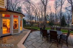 Bluestone and granite patios provide a wonderful setting for relaxing and dining among the outdoor splendor