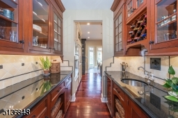 A butler's pantry with a sink, wine refrigerator and generous cabinet space makes hosting effortless.