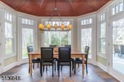 You'll want to start every day in the gorgeous breakfast room surrounded by a wood-trimmed ceiling and walls of windows and French doors framing leafy outdoor views.