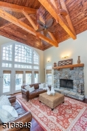 The magnificent family room will become a favorite gathering space with its skyhigh exposed truss ceiling, stone fireplace and French doors that open to the verdant backyard.