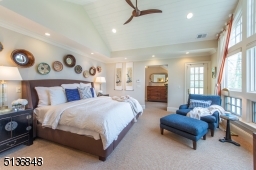 The palatial owner's retreat that opens to a large deck. Luxurious carpeting, a vaulted wood ceiling and access to a large sitting room, custom walk-in closet and laundry room with cedar storage add comfort and convenience.