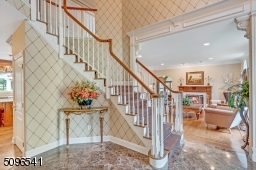 Beautiful entrance with marble floor and soaring ceilings.