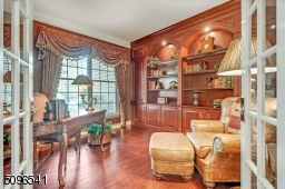 Classic detailed library will custom bookcasases.  Great room for a Zoom call!