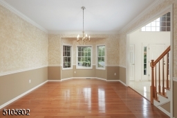 Large formal dining room with gleaming hardwood floors.