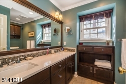 Hall bath with twin sinks and shower over tub