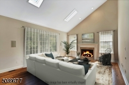 The family room is sundrenched with two large skylights, high ceilings, and windows on every side.