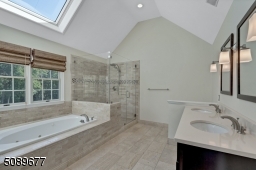 This bathroom is updated and complete with double sinks, jetted tub, and a shower with multiple showerheads. The skylights add beautiful natural light.