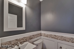 This updated power room has beautiful moldings and tile detail that will impress your guests!