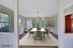 The oversized dining room is surrounded by windows and is completed with elegant wainscoting.