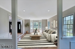 The large living room has a bright bay window, sophisticated moldings and is the perfect space to entertain.