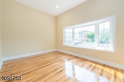 Sunken family room with bay window, new hard wood floors, 12 foot ceilings and recessed lights.