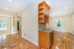 Newly renovated kitchen with new cabinets, new appliances including wine cooler, and new hardwood floors.