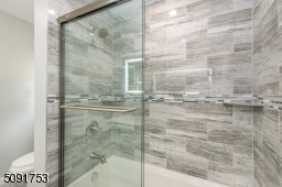 Master bathroom with custom shower doors, touch screen mirrors recessed lighting