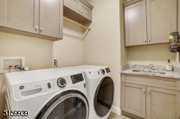 Laundry Room with built-in cabinetry and granite counters