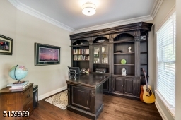 Home Office with hardwood floors, base and crown moldings, double window and a flush mount barrel light fixture