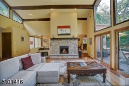 The oversized stone fireplace is double sided into the dining room.