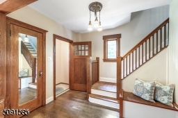 Gracious entry and vestibule warm and inviting foyer with large front hall closet and chestnut details.