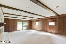 Spacious family room has Beamed ceiling