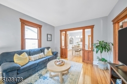 Light filled family room with gorgeous, original woodwork