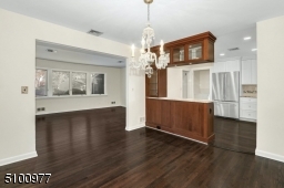 Leading to Living Room and Kitchen. Gorgeous hardwood flooring just refinished and a freshly painted interior.