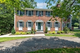 Circular driveway leads to entrance of this lovely center hall colonial