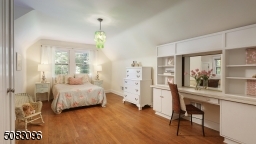 Spacious bedroom with gardwood floors, built-ins and beautiful view of backyard
