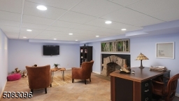Lower level Rec room with arched stone wood-burning fireplace (current owner has never used)