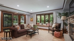 Natural light streams in this fabulous family room with sliders out to brick patio with grapevine covered arbor