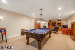 Navy pool table included in the large entertaining space.
