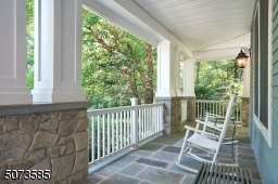 Relax on your bluestone porch overlooking over your private 1.5 acres.