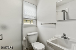 Full Bathroom with tile floors, glass-enclosed shower, flushmount light and a medicine chest