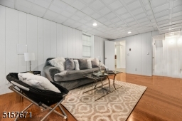 Recreation Room with hardwood floors, recessed lights and a wet bar