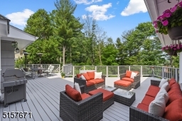 Bring the party OUTSIDE this summer to the sweeping rear deck with spectacular sunset views.