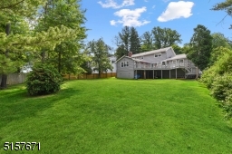 Large level yard is landscaped to perfection and fenced on three sides.