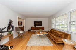 Sun filled living room picture window wood floors