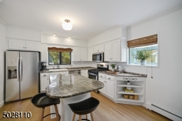 Renovated Chef?s Kitchen featuring newly refinished hardwood floors, new moldings, recessed lighting, granite countertops, stainless steel appliances including Bosch dishwasher and  LG refrigerator and decorative open shelving