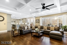 Family room with coffered ceiling and sliding French doors lead to backyard