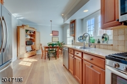Sunny and bright renovated Eat in kitchen with Quartz countertops and stainless appliances.