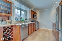 Renovated Kitchen featuring custom cabinets, wine bar and quartz counters.